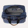 Blue tote bag with open front compartment on a light gray background