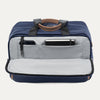 Blue tote bag showing front open compartment  with phone and notepad on a light gray background