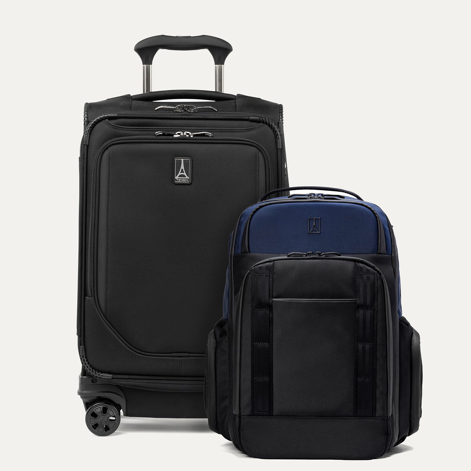 A set of two pieces of luggage, featuring a black carry-on spinner and a aviator navy laptop backpack, on a white background