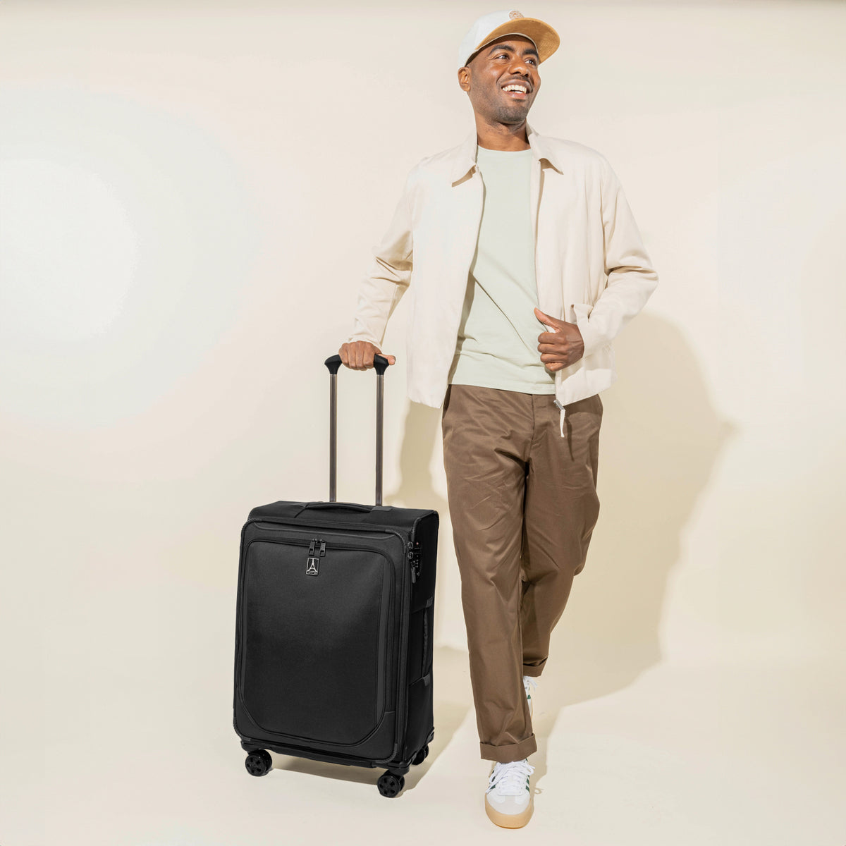 Person holding a black suitcase on a white background