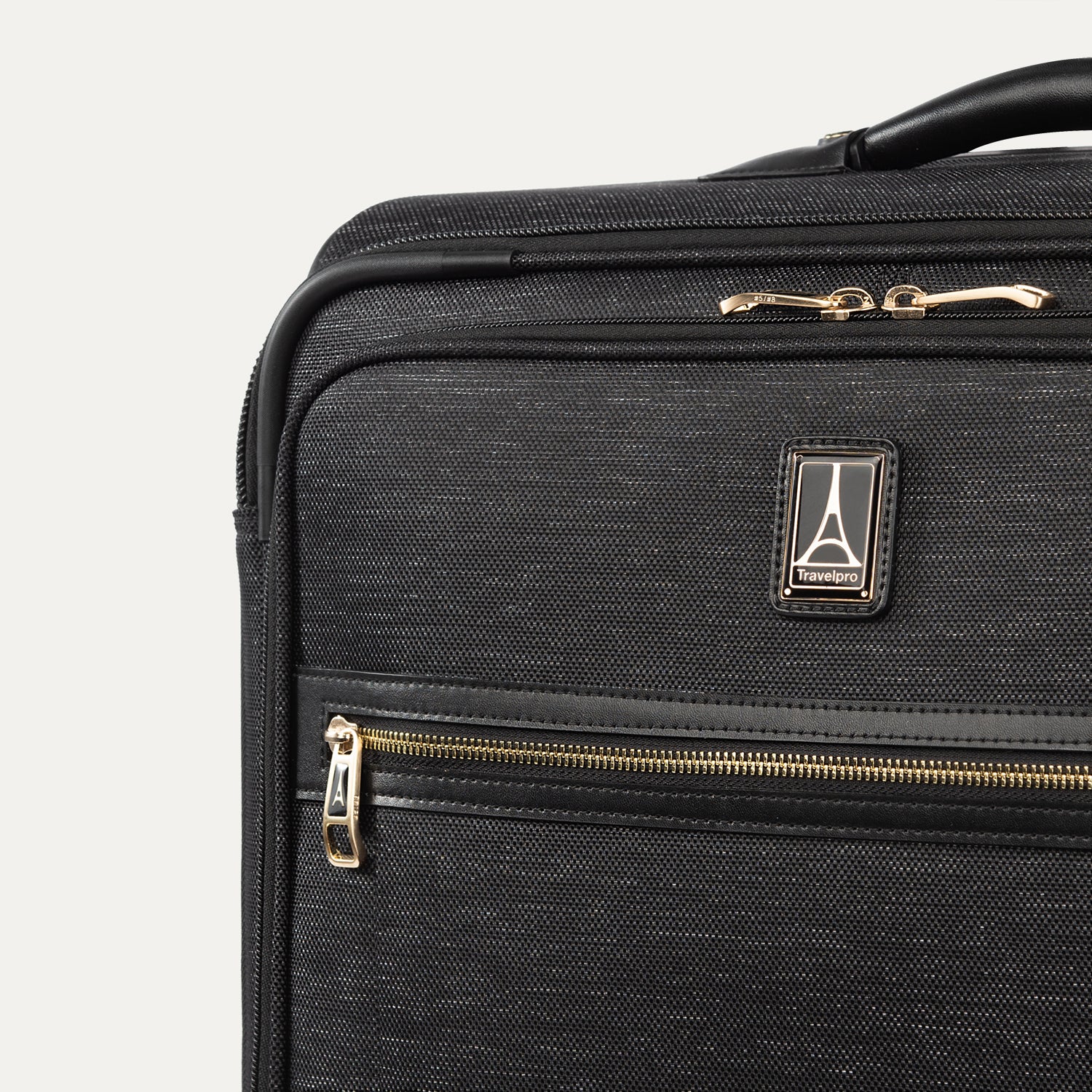 Black suitcase with gold zippers on a white background