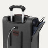 Close-up of gray suitcase with extended handle and visible USB charging cable, on white background