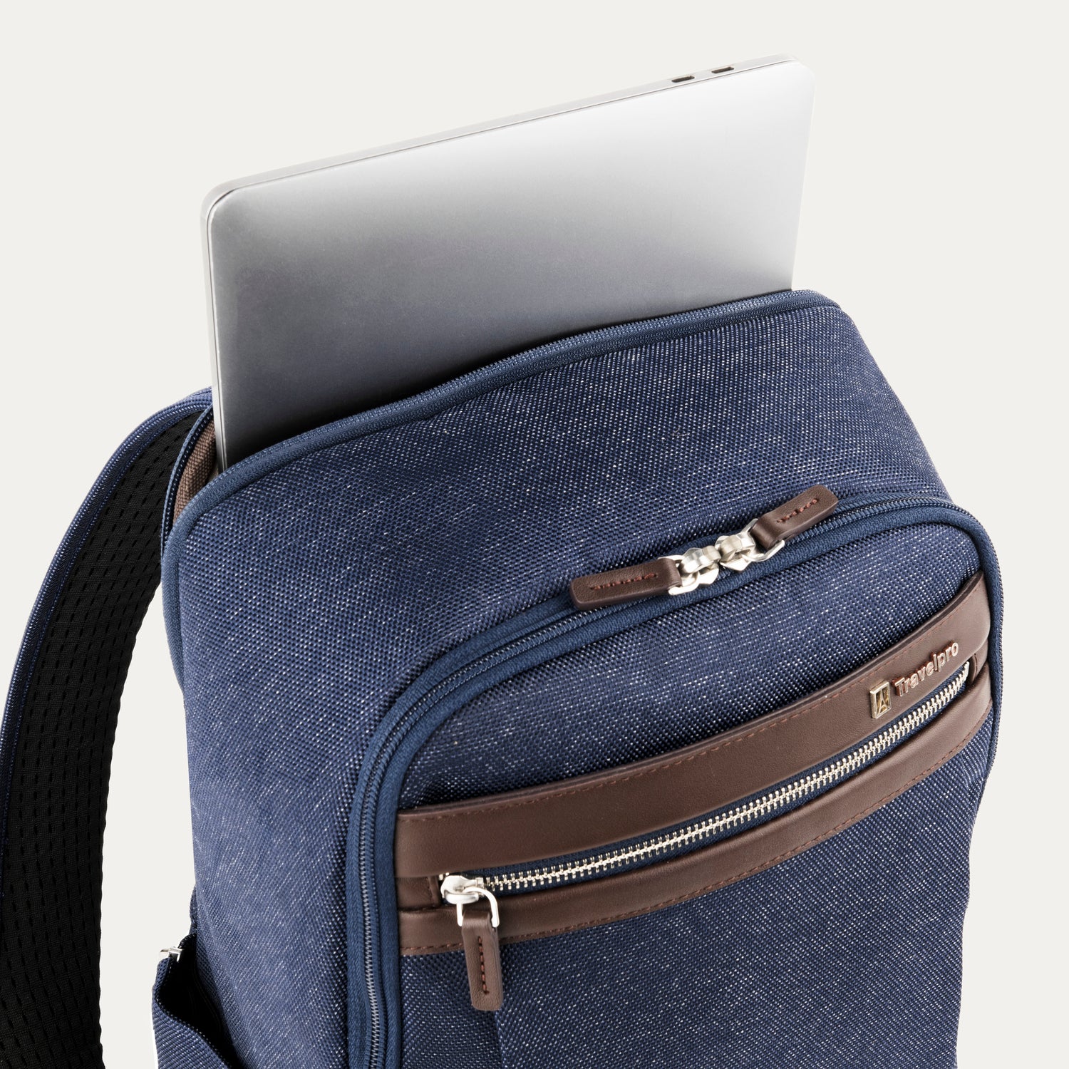 True navy backpack with laptop visibly stored in the dedicated sleeve compartment.

