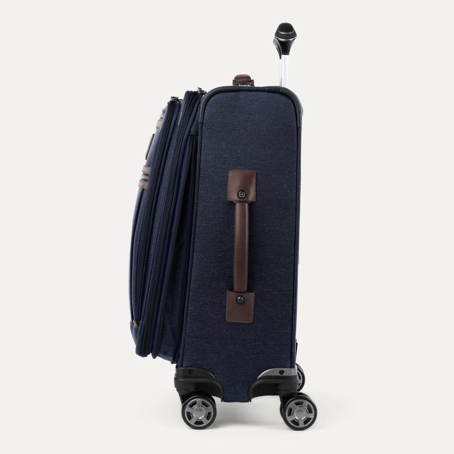 Side view of expanded blue suitcase with brown side handle on a white background
