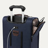 Close-up of blue suitcase with extended handle and visible USB charging cable, on white background