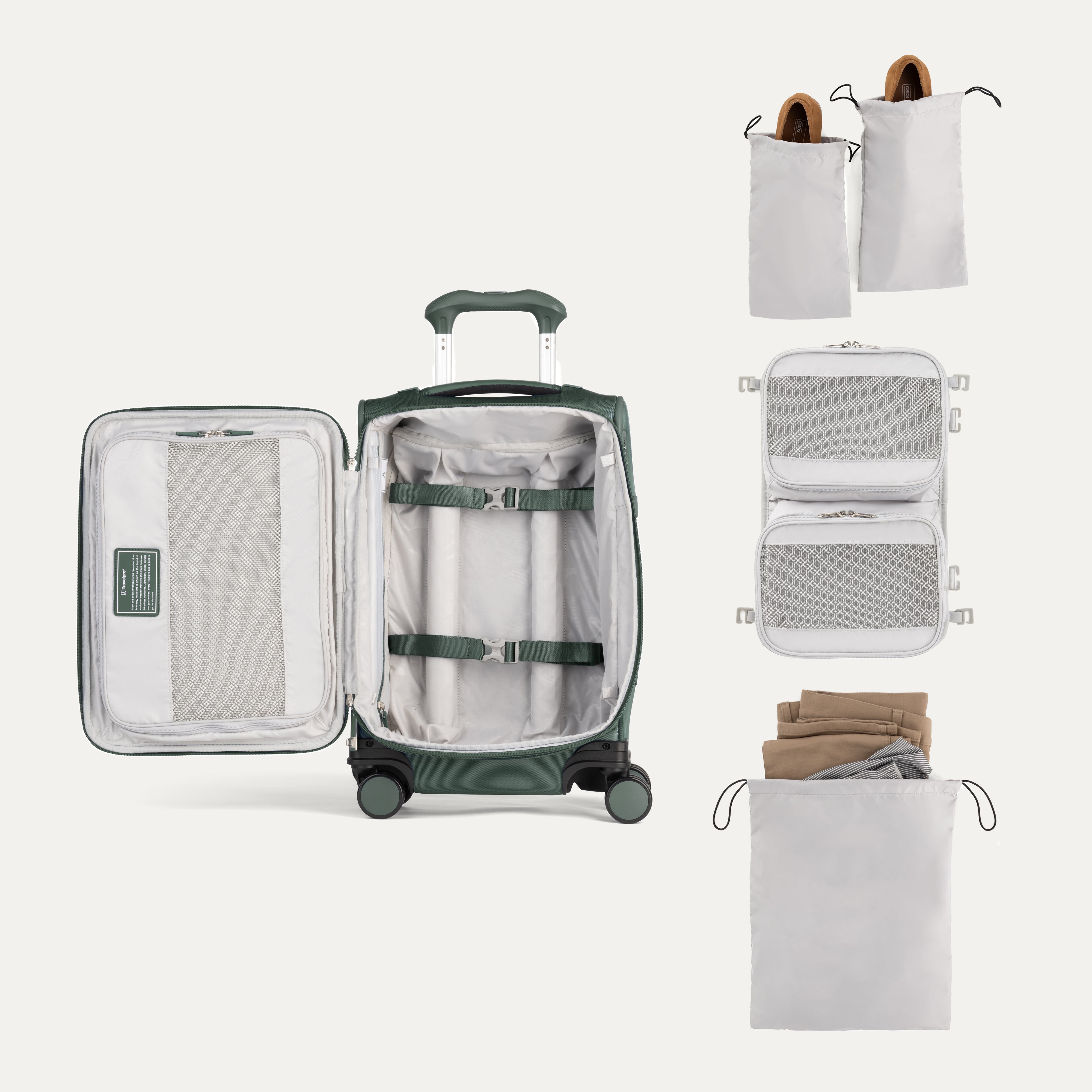 Green suitcase with travel packing cubes and bags on a white background