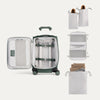 Green suitcase with travel packing cubes and bags on a white background