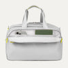 Front view of VersaPack®+ UnderSeat Tote in Cyber Lime, showing dual carry handles and an open exterior pocket with a phone and passport for easy access.
